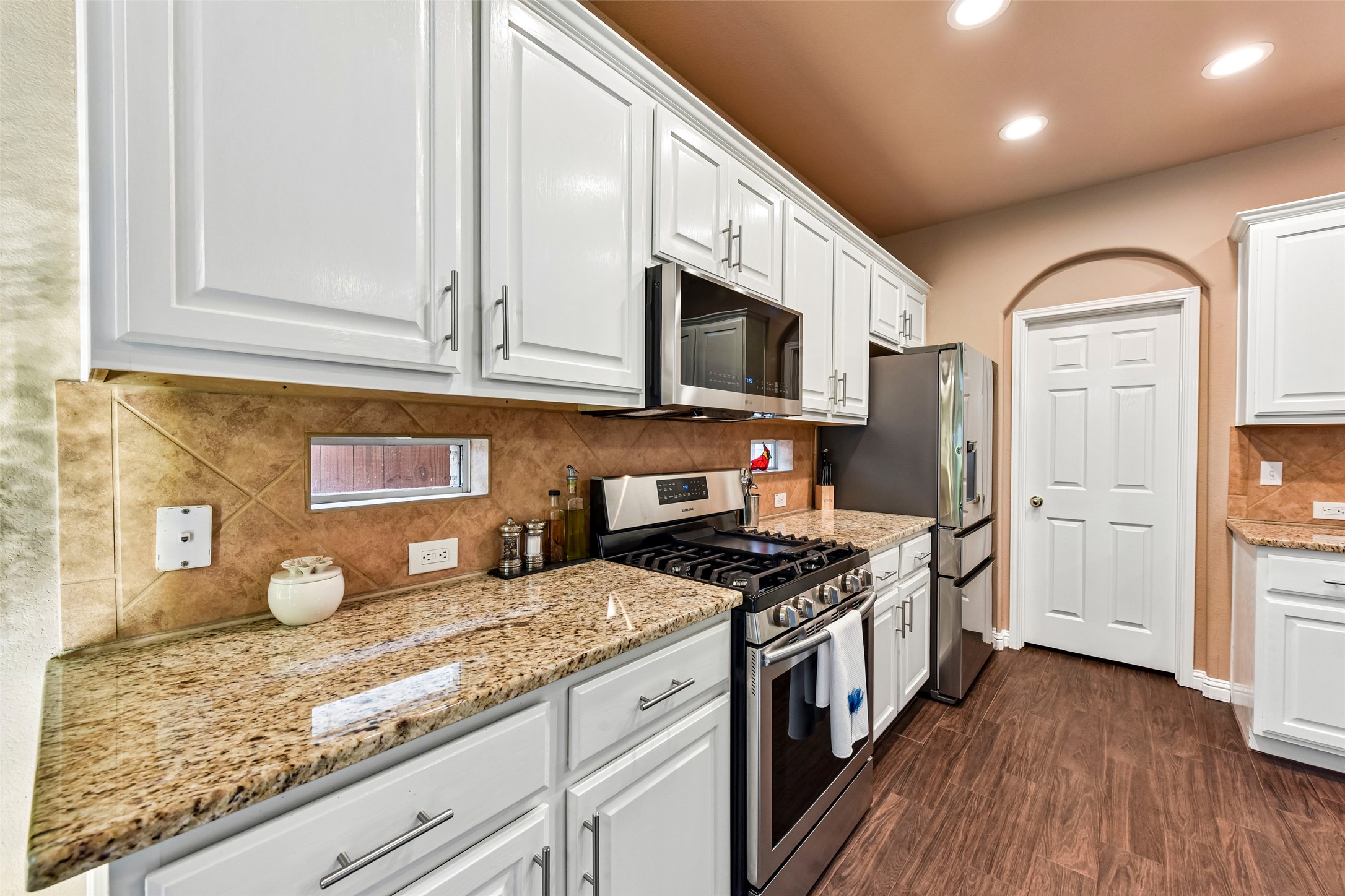 10216 Anahuac Trail Austin, TX 78747 - Photo 16 of 39 a kitchen with stainless steel appliances granite countertop a stove a sink and a refrigerator