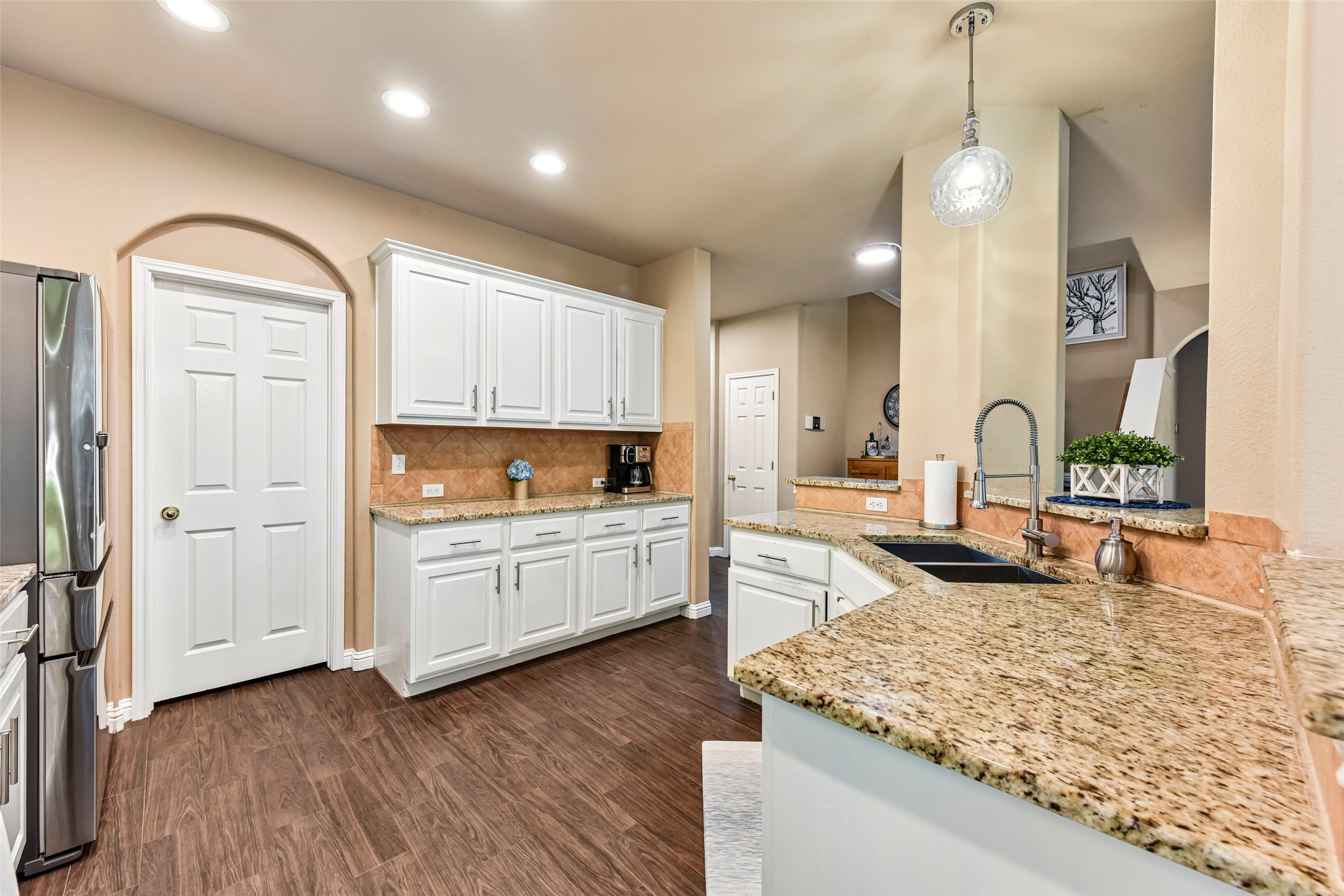 10216 Anahuac Trail Austin, TX 78747 - Photo 17 of 39 a kitchen with sink refrigerator and cabinets