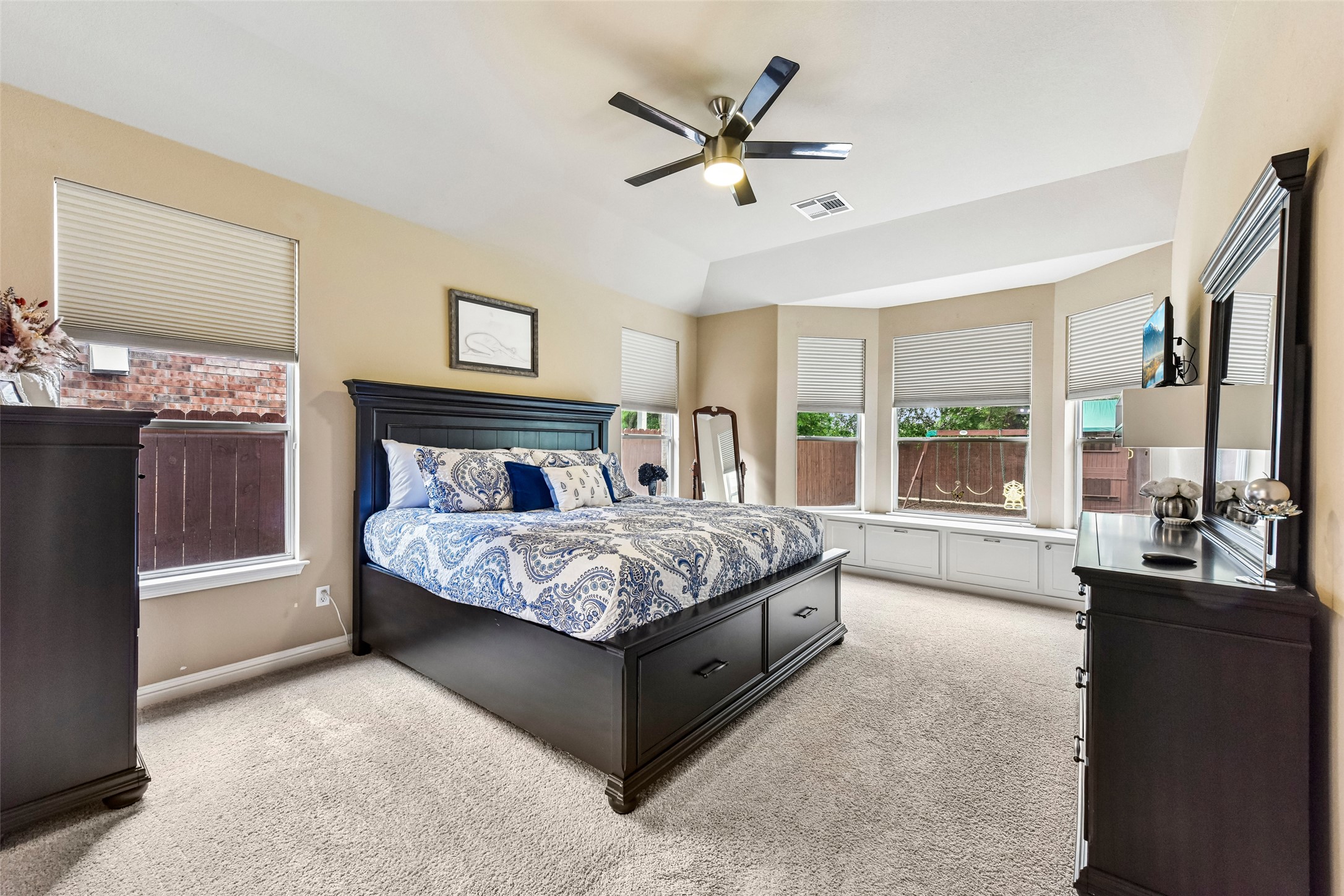10216 Anahuac Trail Austin, TX 78747 - Photo 22 of 39 a spacious bedroom with a large bed and a chandelier fan
