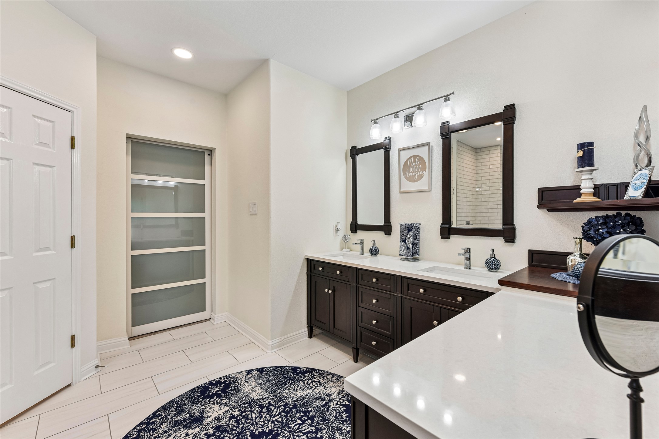 10216 Anahuac Trail Austin, TX 78747 - Photo 23 of 39 a spacious bathroom with a sink double vanity and a mirror