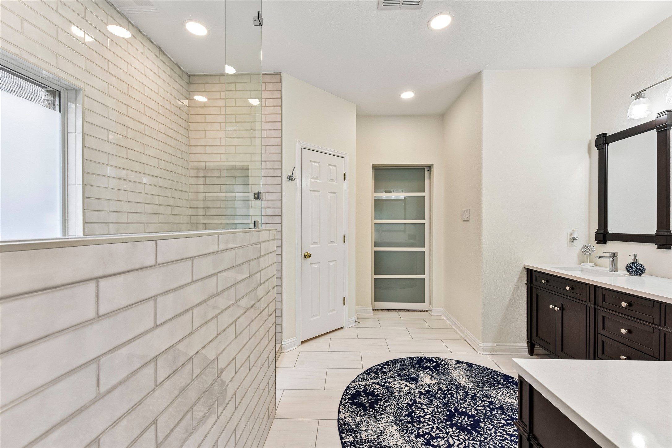 10216 Anahuac Trail Austin, TX 78747 - Photo 24 of 39 a spacious bathroom with a sink a vanity and a mirror