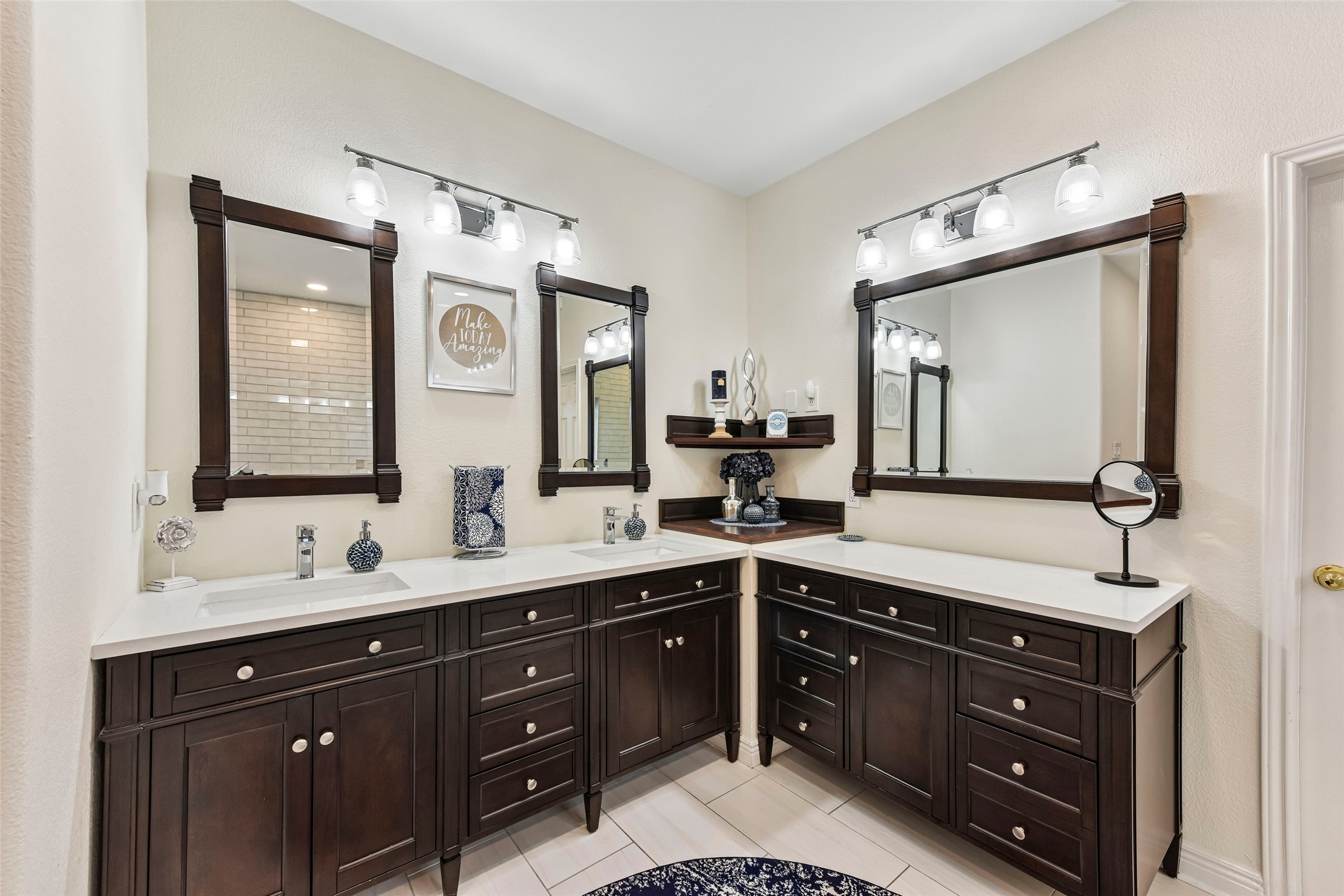 10216 Anahuac Trail Austin, TX 78747 - Photo 26 of 39 a bathroom with a double vanity sink and mirror with shower