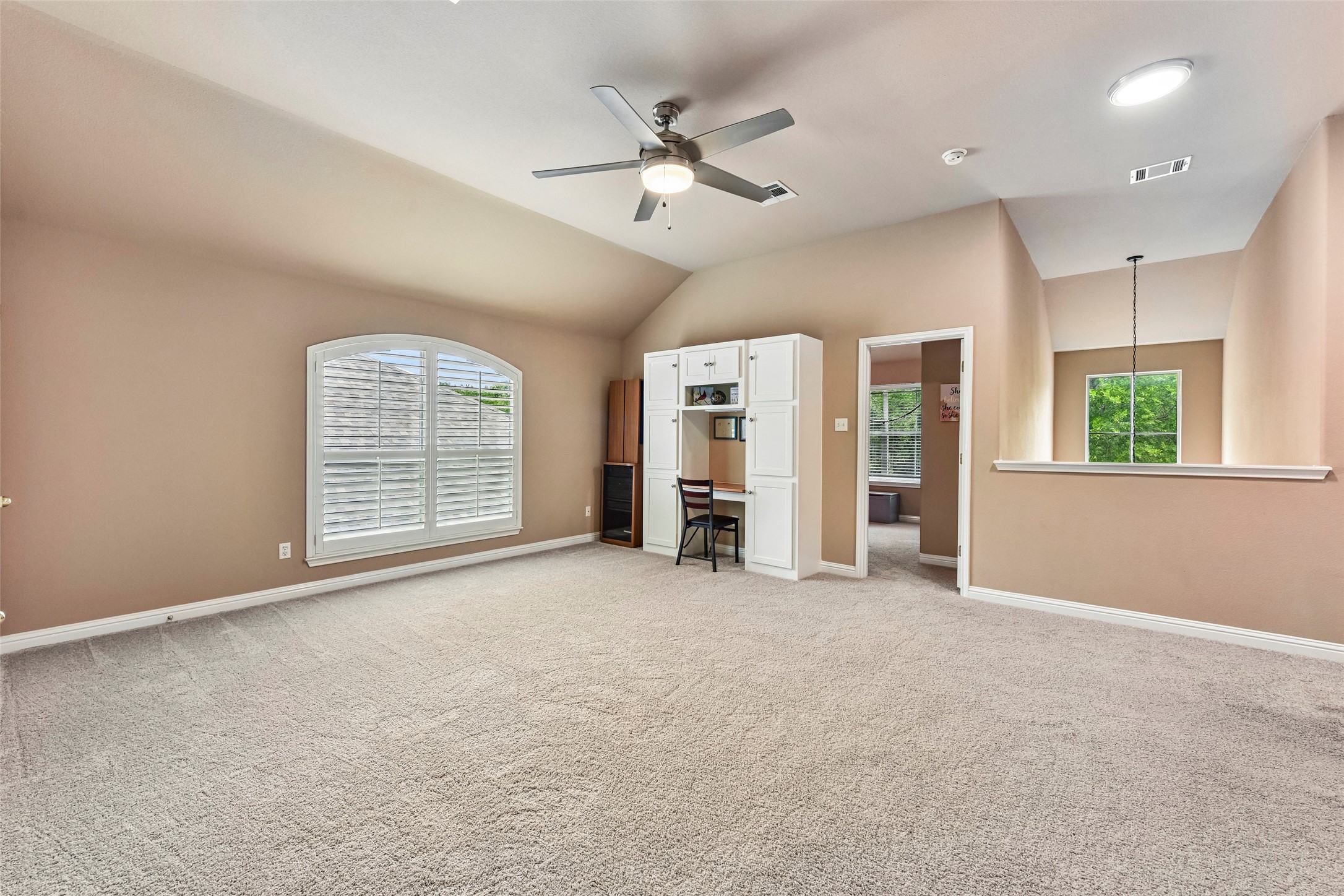 10216 Anahuac Trail Austin, TX 78747 - Photo 29 of 39 an empty room with windows and ceiling fan