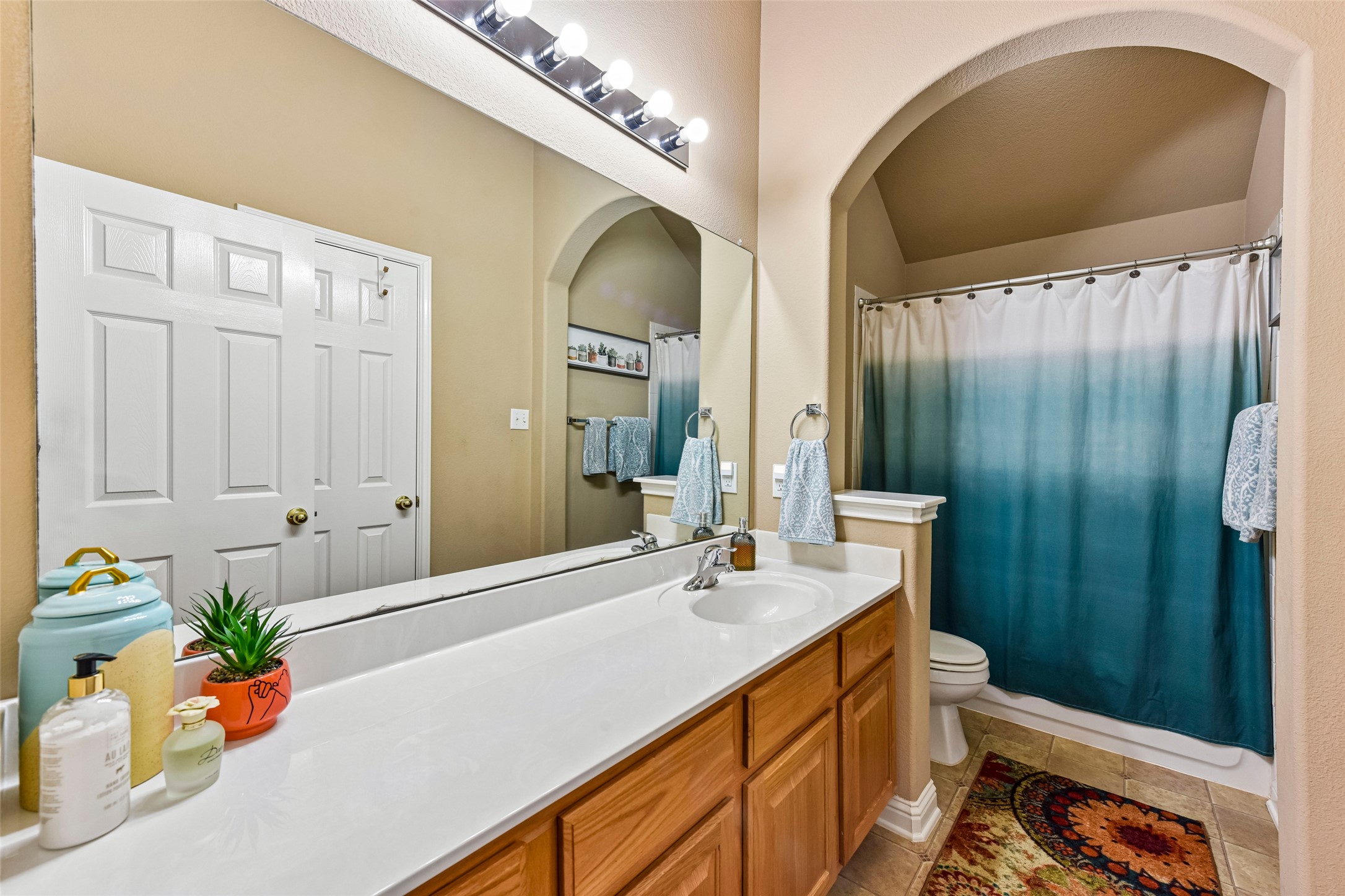 10216 Anahuac Trail Austin, TX 78747 - Photo 32 of 39 a bathroom with a sink a vanity and a mirror