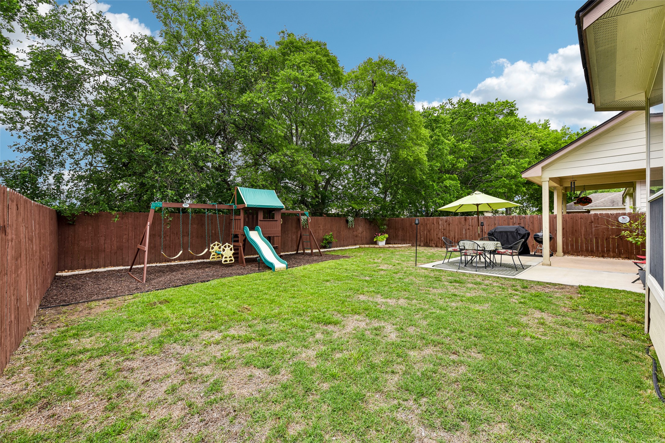 10216 Anahuac Trail Austin, TX 78747 - Photo 36 of 39 a view of a backyard with table and chairs and potted plants and big trees