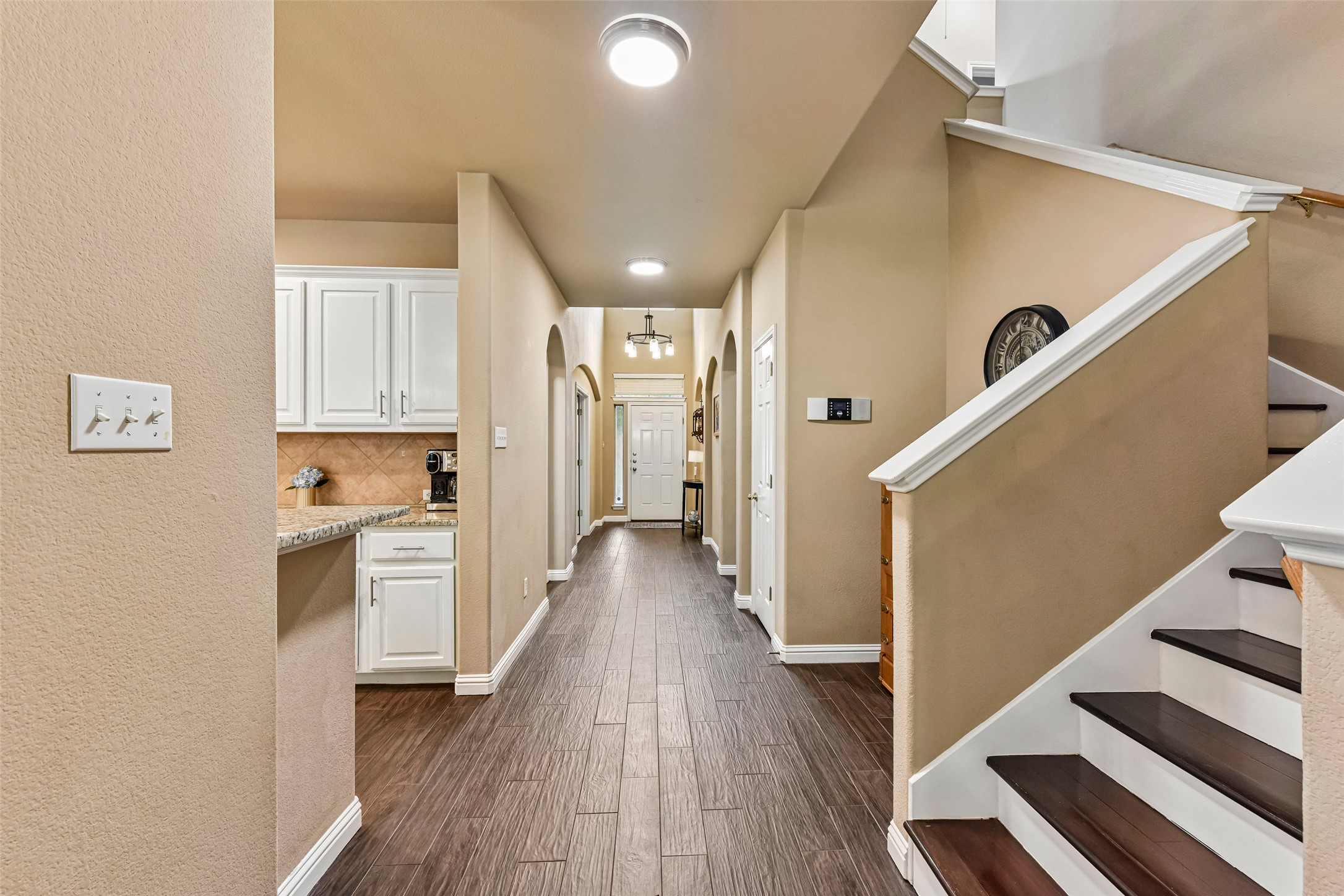 10216 Anahuac Trail Austin, TX 78747 - Photo 5 of 39 a view of a hallway with wooden floor and staircase