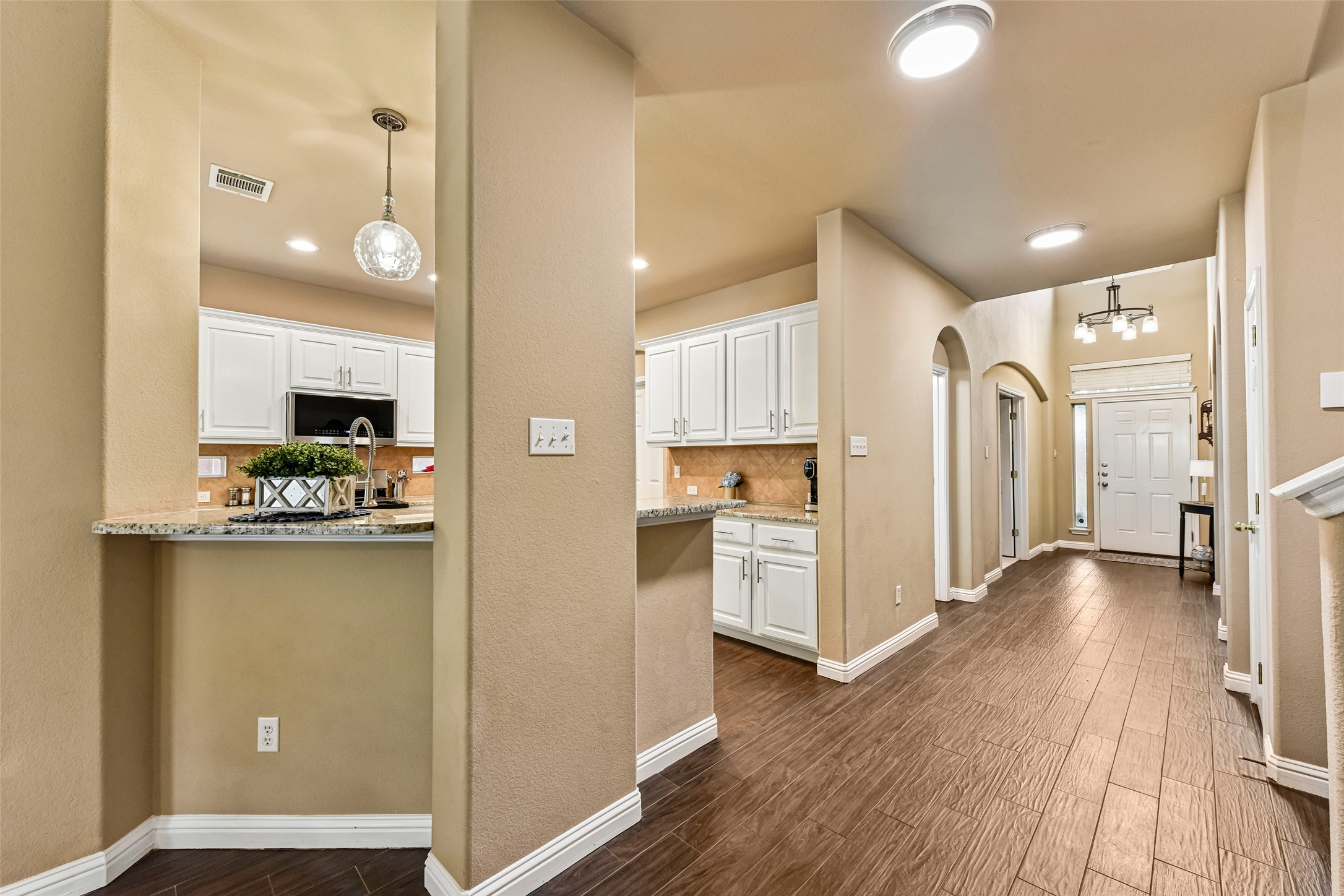 10216 Anahuac Trail Austin, TX 78747 - Photo 6 of 39 a view of a kitchen cabinets and wooden floor