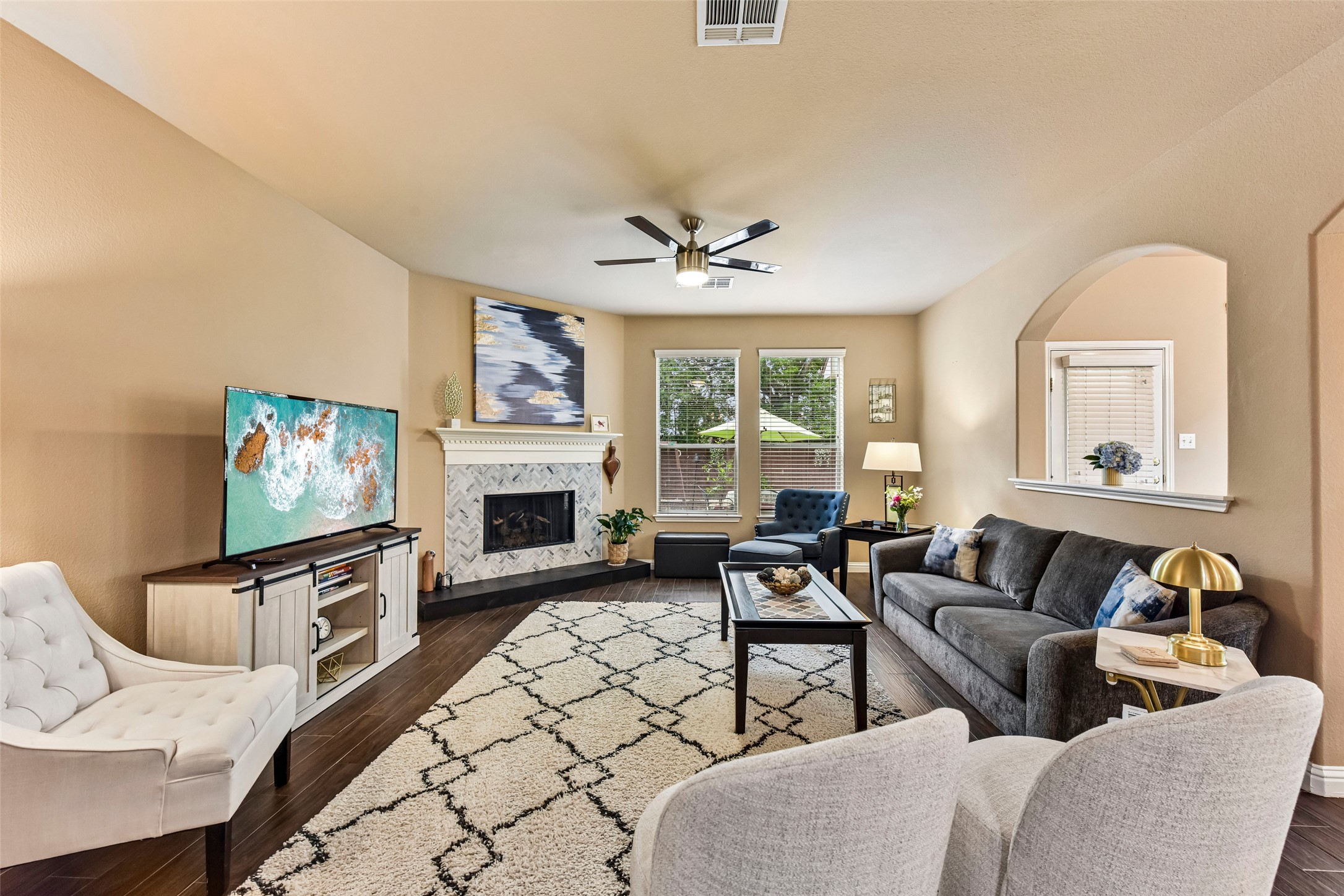 10216 Anahuac Trail Austin, TX 78747 - Photo 8 of 39 a living room with furniture a fireplace and a flat screen tv