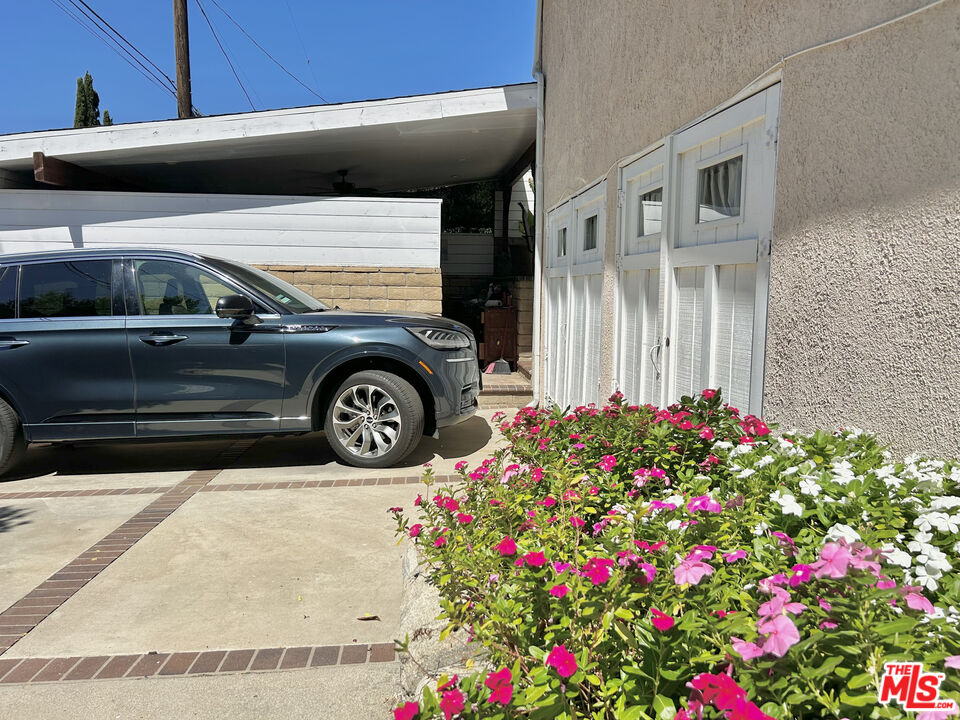 10205 Fairgrove Avenue Tujunga, CA 91042 - Photo 16 of 21 a view of a house with a cars park side of a road