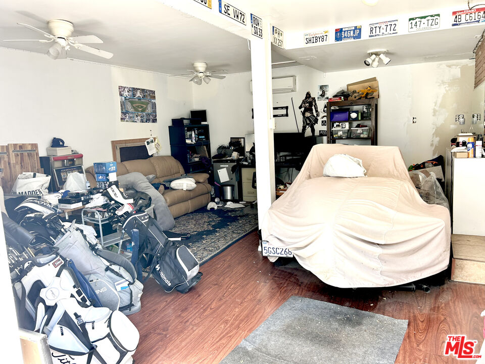 10205 Fairgrove Avenue Tujunga, CA 91042 - Photo 17 of 21 a living room with furniture and a chandelier