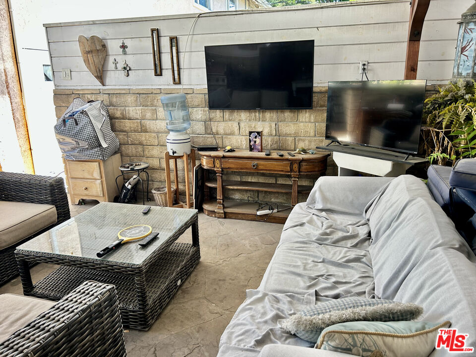 10205 Fairgrove Avenue Tujunga, CA 91042 - Photo 19 of 21 a living room with furniture and a flat screen tv