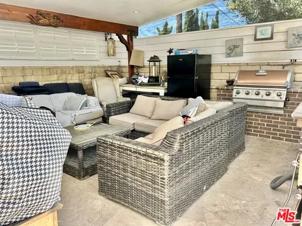 an aerial view of a house with outdoor space patio and trees all around
