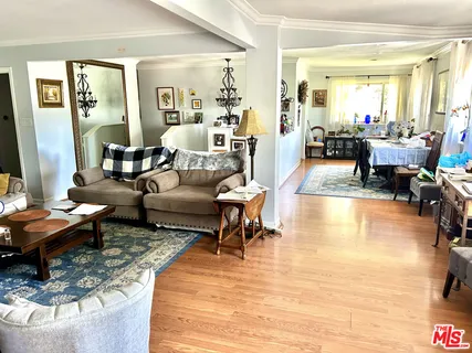 a living room with fireplace furniture and a large window