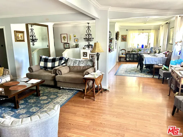 a living room with fireplace furniture and a large window
