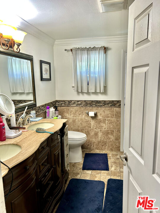 10205 Fairgrove Avenue Tujunga, CA 91042 - Photo 9 of 21 a bathroom with a sink and a mirror