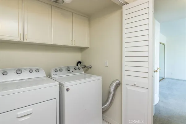 a view of storage and utility room with washer and dryer