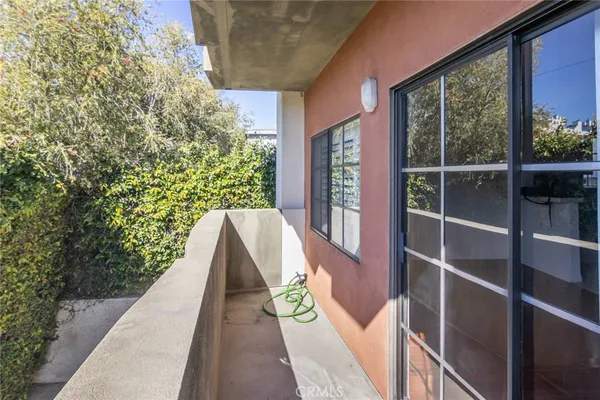 a view of a balcony with flower plants