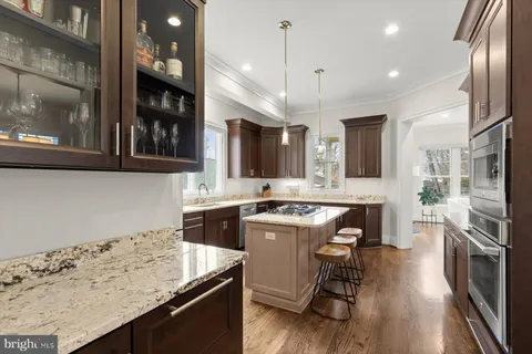 a kitchen with a sink stove and refrigerator