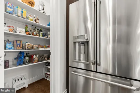 a kitchen with an oven a refrigerator and cabinets