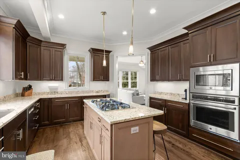 a kitchen with a sink stove and microwave