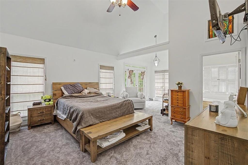 409 Windsor Way Canton, GA 30115 - Photo 13 of 51 a bedroom with a bed and wooden floor