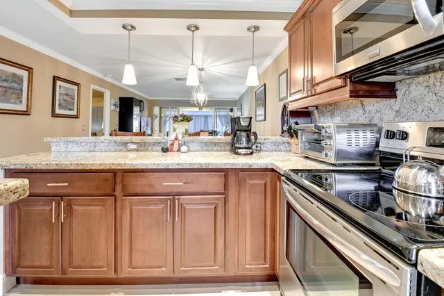 a kitchen with stainless steel appliances granite countertop a sink and cabinets