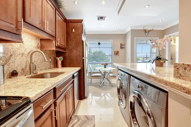 a kitchen with granite countertop a sink and cabinets