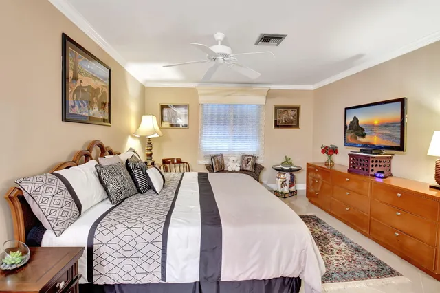 a bed room with bed and a flat screen tv