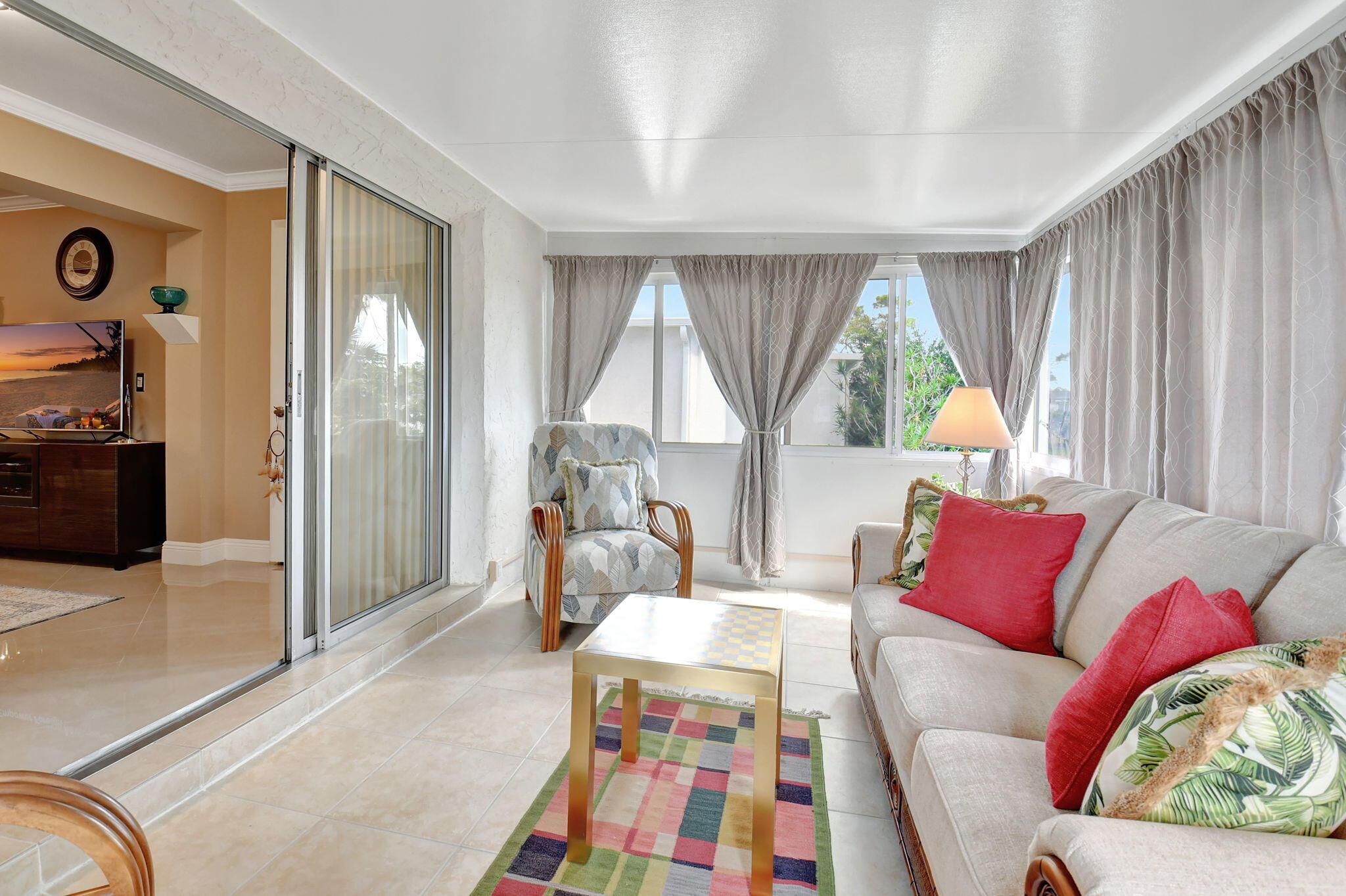 2721 Southwest 15th Street, Unit 203 Delray Beach, FL 33445 - Photo 29 of 55 a living room with furniture and a window
