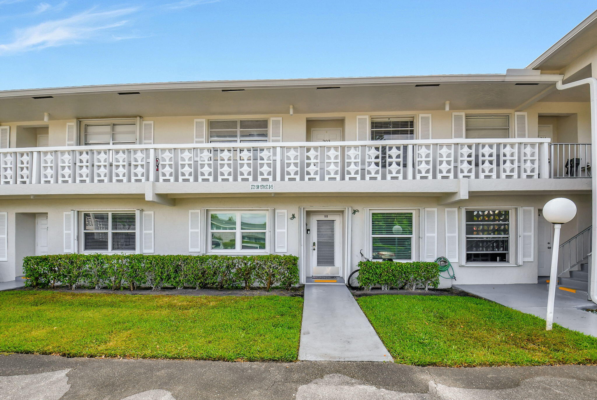 2721 Southwest 15th Street, Unit 203 Delray Beach, FL 33445 - Photo 3 of 55 a front view of a house with garden