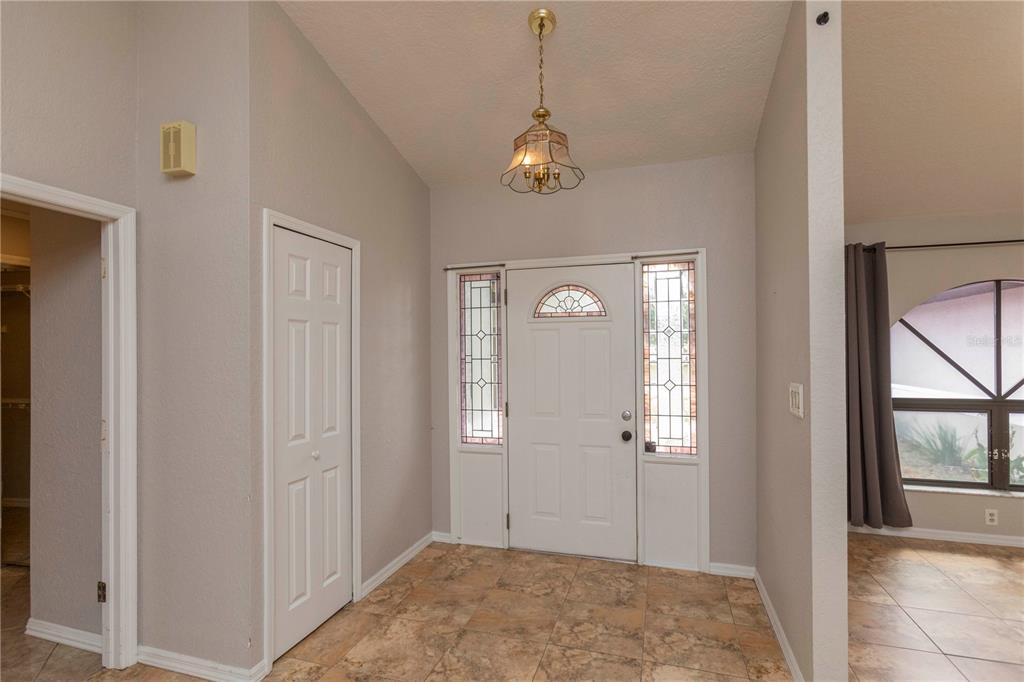 5701 Mossberg Drive New Port Richey, FL 34655 - Photo 15 of 58 a view of a hallway with wooden floor and a livingroom