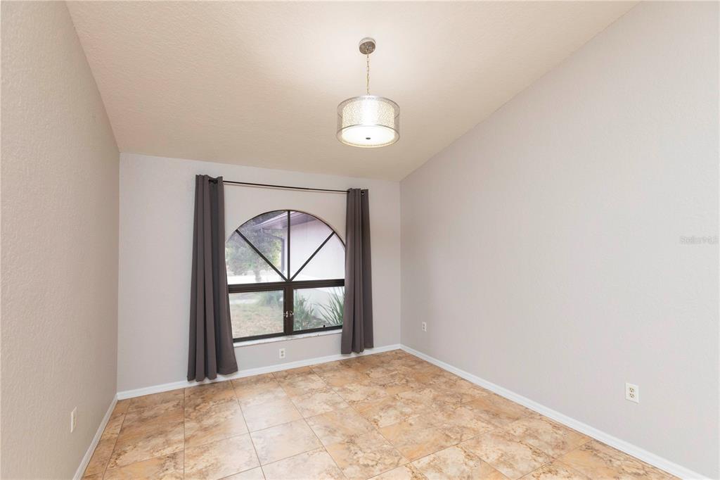 5701 Mossberg Drive New Port Richey, FL 34655 - Photo 16 of 58 an empty room with cabinet and windows