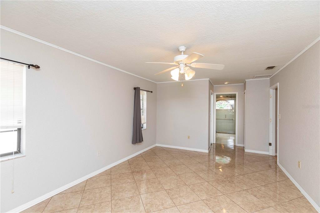 5701 Mossberg Drive New Port Richey, FL 34655 - Photo 24 of 58 an empty room with chandelier fan and windows