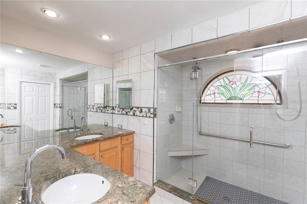 5701 Mossberg Drive New Port Richey, FL 34655 - Photo 25 of 58 a bathroom with a granite countertop sink mirror vanity and toilet