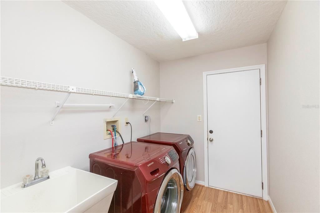 5701 Mossberg Drive New Port Richey, FL 34655 - Photo 34 of 58 a utility room with dryer and washer
