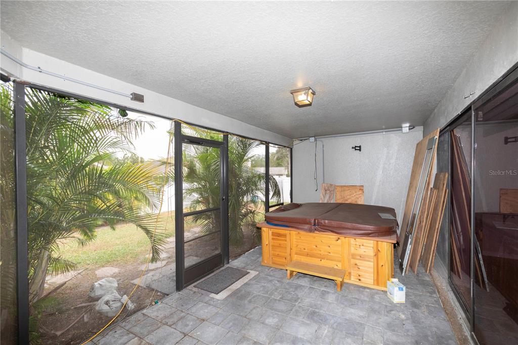 5701 Mossberg Drive New Port Richey, FL 34655 - Photo 40 of 58 a room with kitchen island granite countertop a refrigerator and a sink