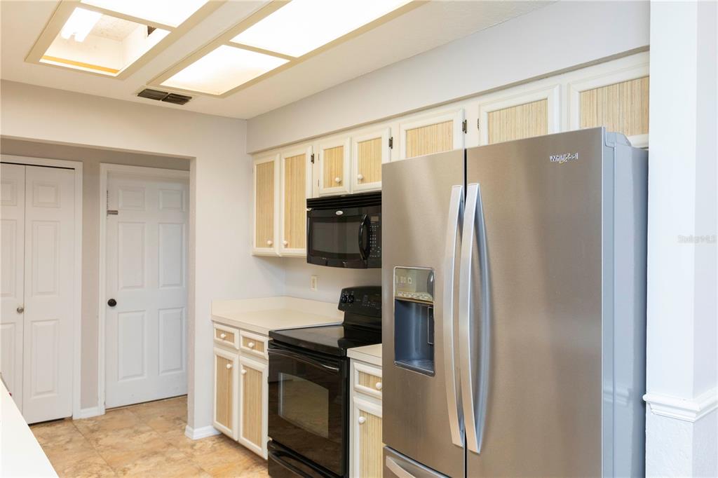 5701 Mossberg Drive New Port Richey, FL 34655 - Photo 7 of 58 a kitchen with stainless steel appliances granite countertop a refrigerator and a stove