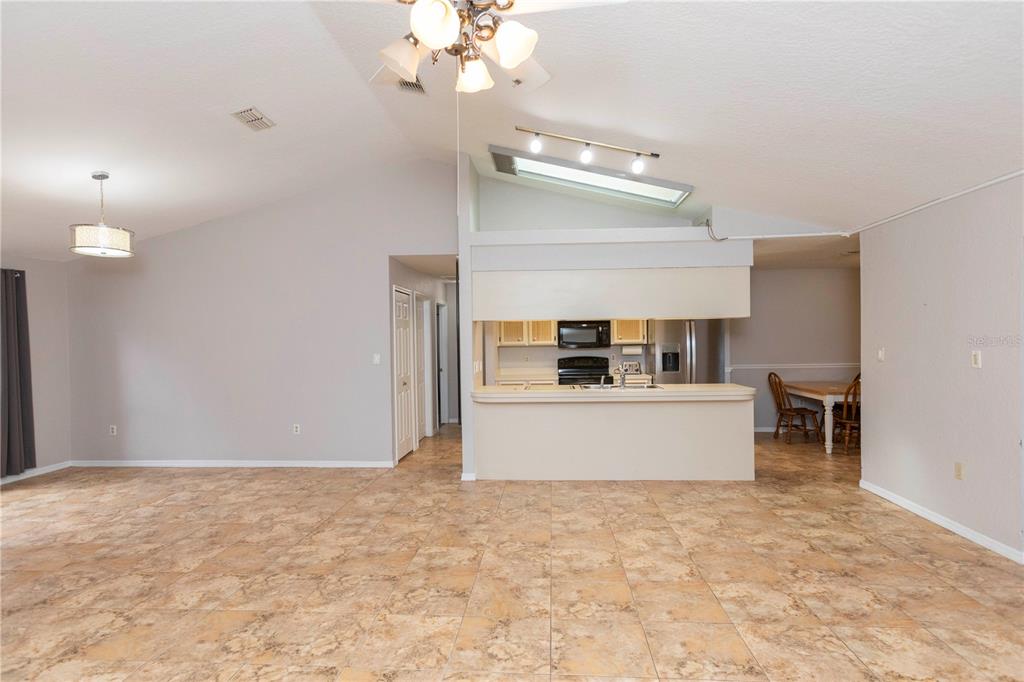5701 Mossberg Drive New Port Richey, FL 34655 - Photo 10 of 58 a view of kitchen center island and living room