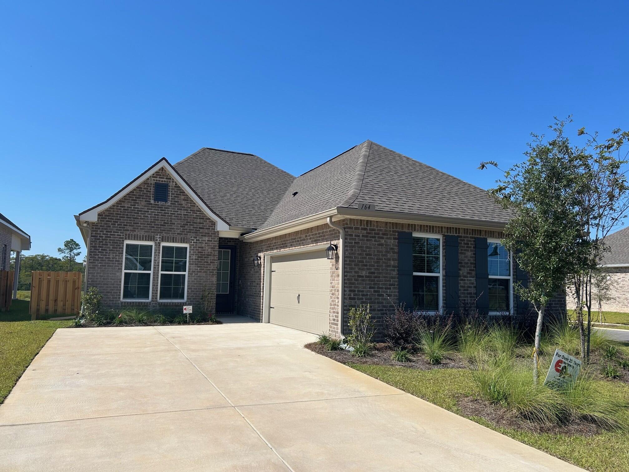 164 Splendor Run Ponce de Leon, FL 32455 - Photo 1 of 3 a front view of a house with a yard and garage