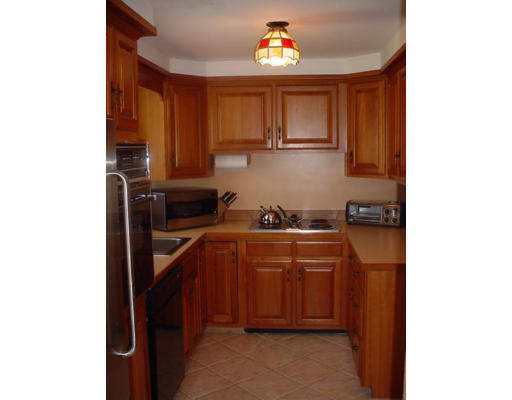 7 Lyman Road Framingham, MA 01701 - Photo 3 of 6 a kitchen with stainless steel appliances granite countertop a refrigerator and a stove top oven