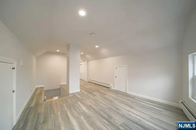 a view of an empty room with wooden floor