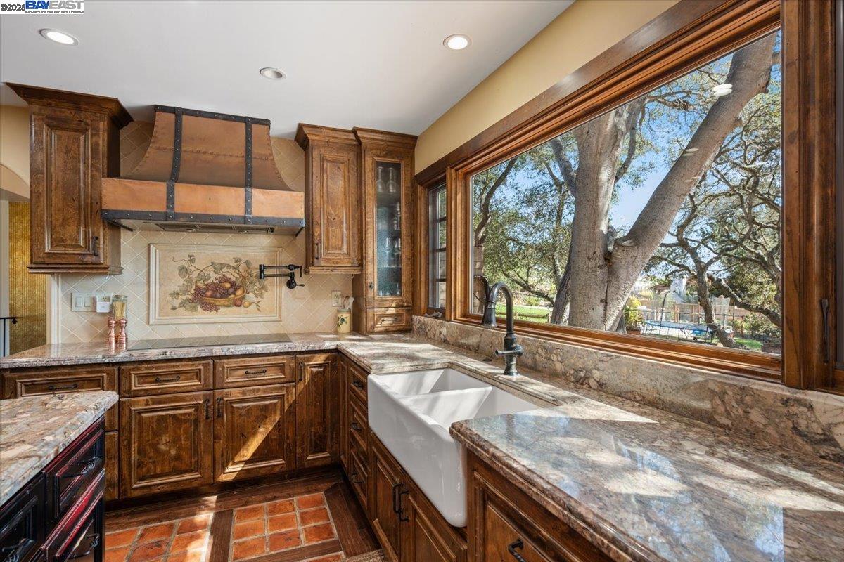298 St Andrews Way Lompoc, CA 93436 - Photo 13 of 56 a kitchen that has a sink and a stove in it