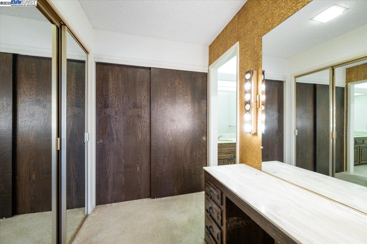298 St Andrews Way Lompoc, CA 93436 - Photo 21 of 56 a bathroom with a granite countertop sink and a mirror