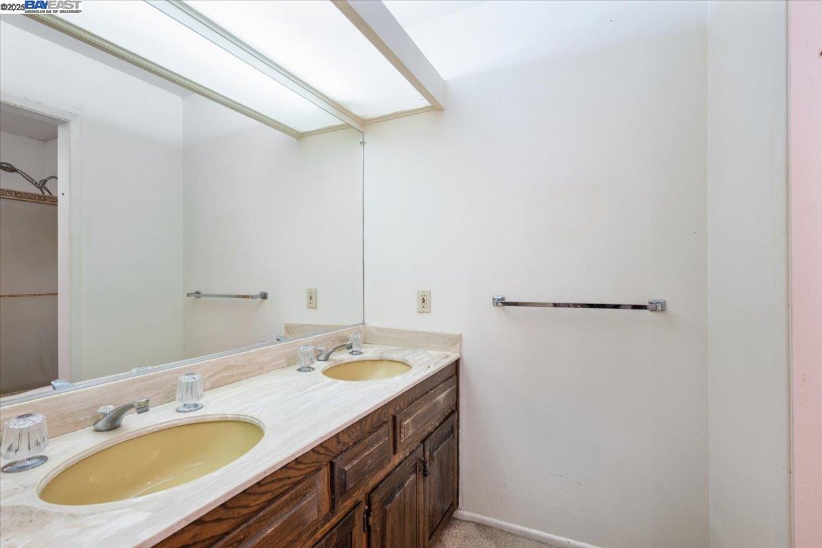 298 St Andrews Way Lompoc, CA 93436 - Photo 22 of 56 a bathroom with a granite countertop sink and a mirror