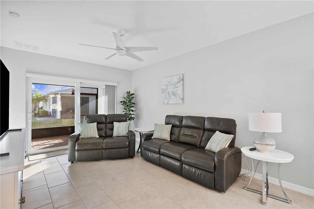 6187 Red Maple Manor Vero Beach, FL 32966 - Photo 11 of 31 a living room with furniture and a large window