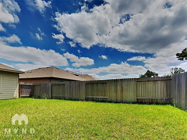 an aerial view of a house with a yard and lake view