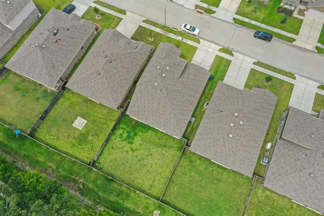 an aerial view of a house with a yard