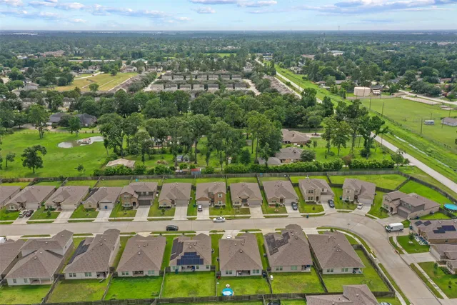 an aerial view of residential houses with outdoor space