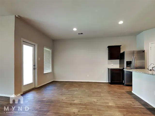 a view of a livingroom with a kitchen