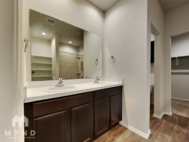 a bathroom with a double vanity sink and mirror